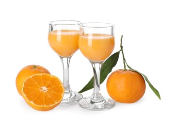 Photo of Tasty tangerine liqueur in glasses and fresh citrus fruits isolated on white