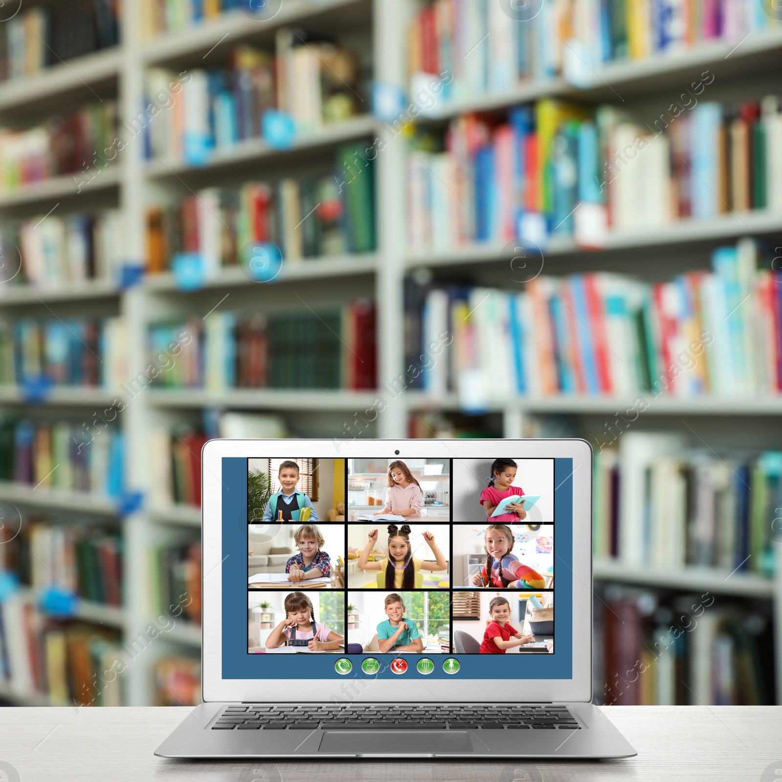 Image of Distance education during quarantine and lockdown due to Covid-19 pandemic. Modern laptop with online classroom on screen in library