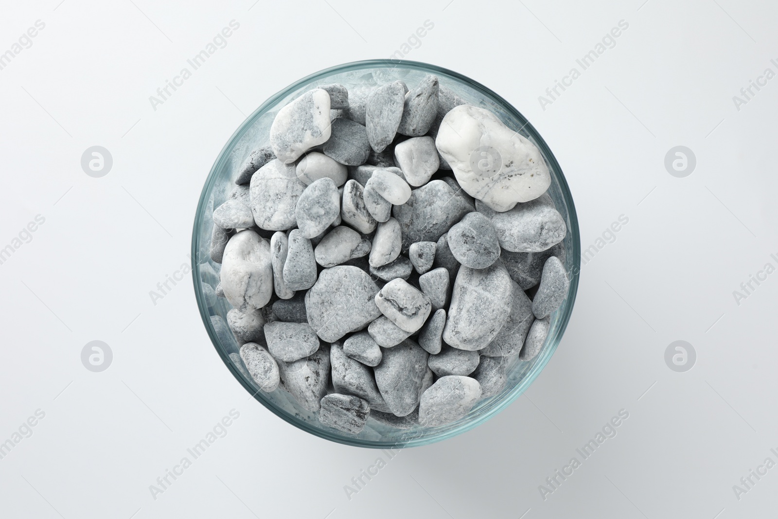 Photo of Presentation for product. Glass container with stones on light grey background, top view