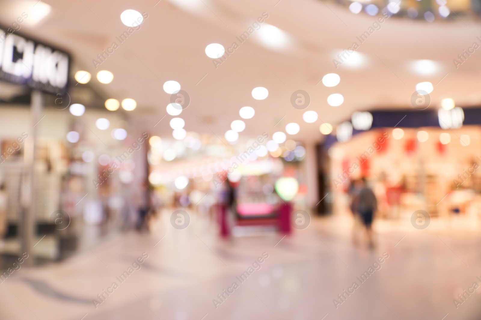 Photo of Blurred view of modern shopping mall interior. Bokeh effect