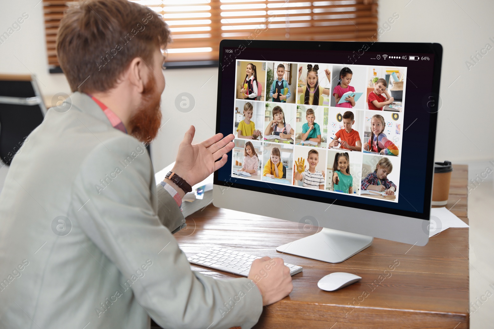 Image of Teacher giving online school lesson during quarantine and social distancing due to Covid-19 pandemic. Pupils studying at home via video conference