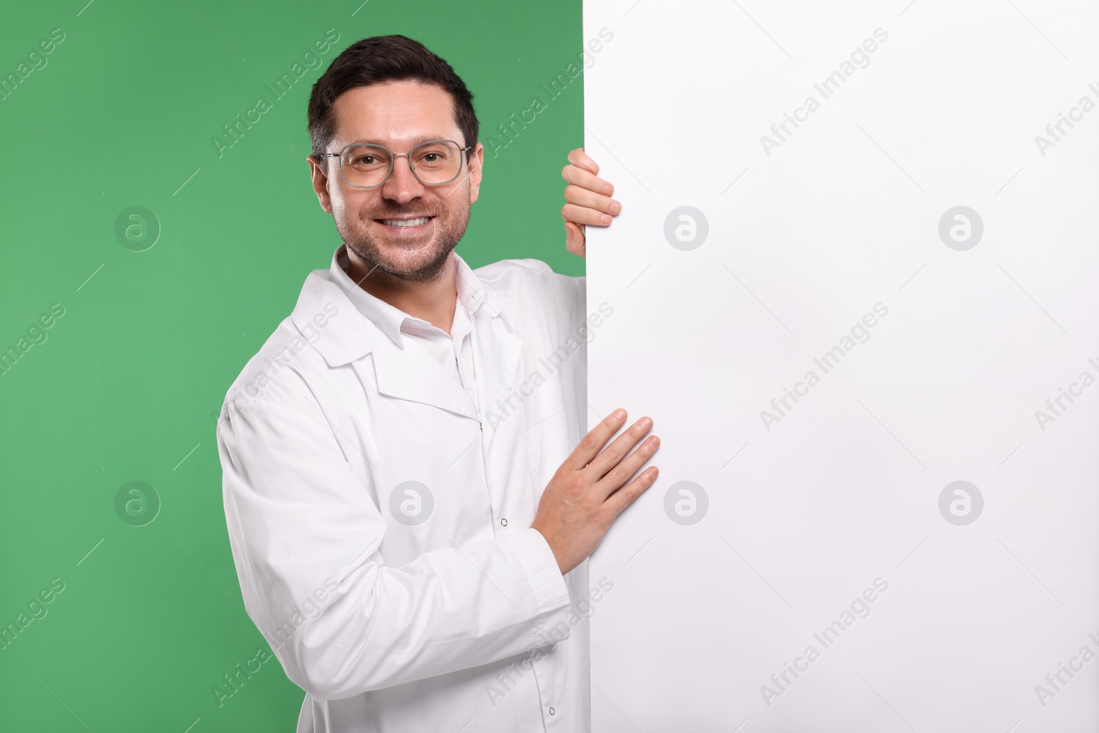 Photo of Ophthalmologist with blank banner on green background, space for text