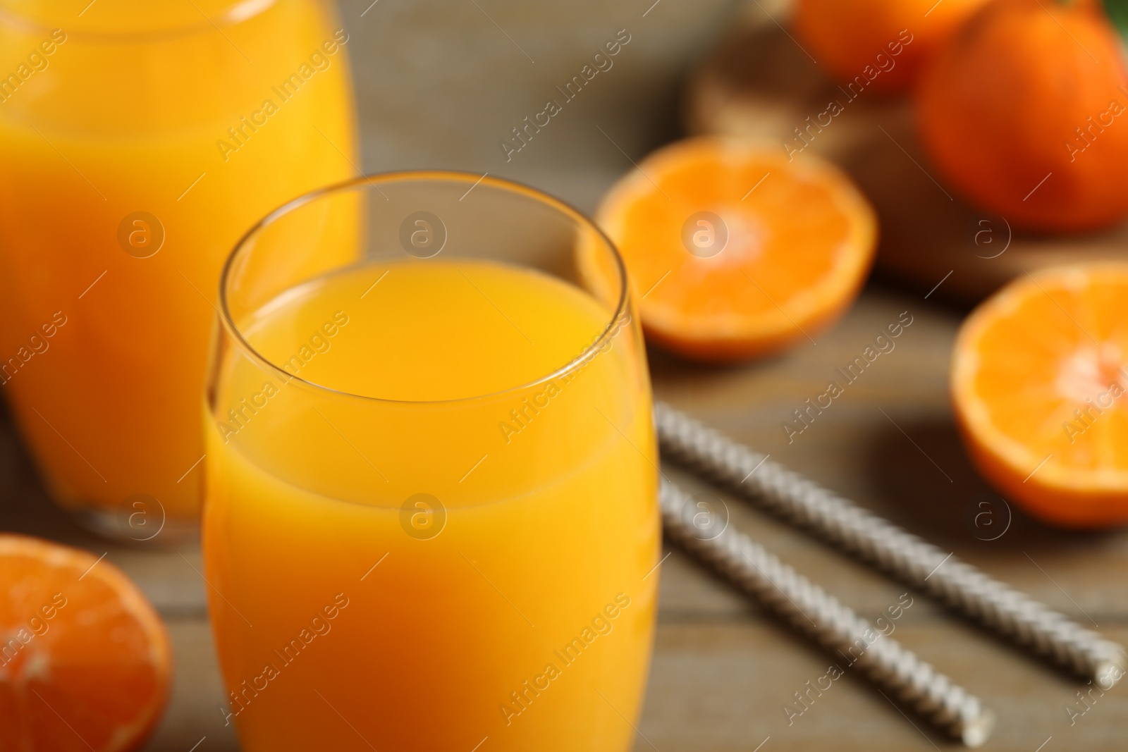 Photo of Glass of fresh tangerine juice, closeup view