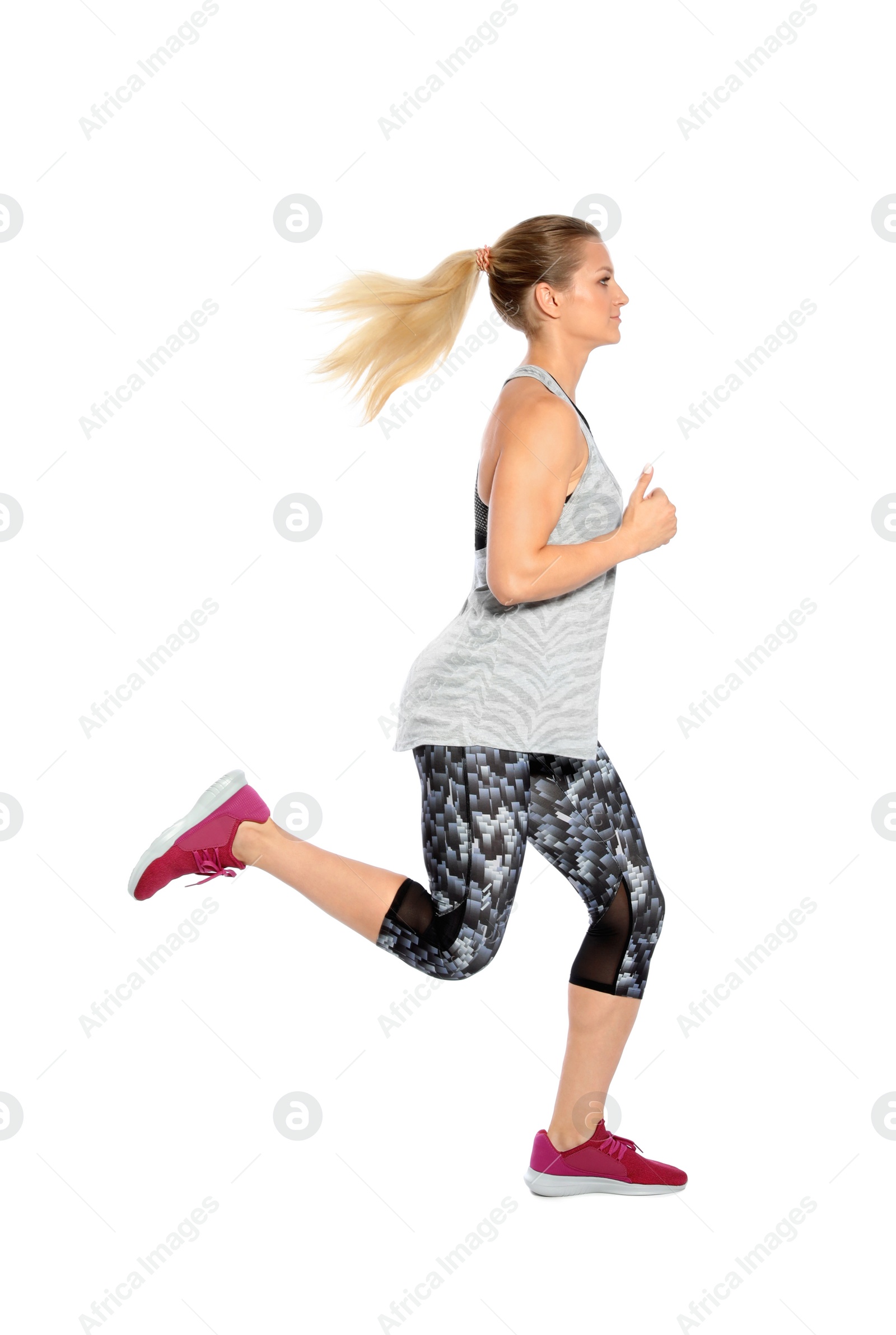 Photo of Sporty young woman running on white background