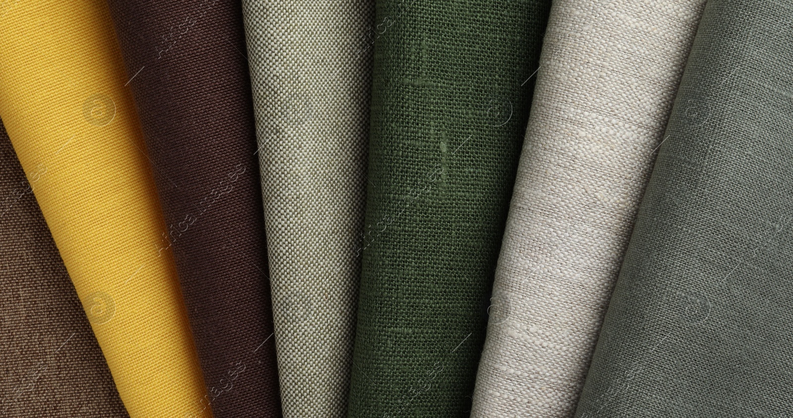 Photo of Many different fabrics on brown cloth, top view