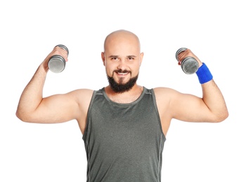 Overweight man doing exercise with dumbbells on white background