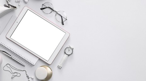 Photo of Flat lay composition with modern tablet on white background. Space for text