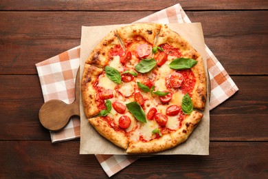 Photo of Delicious Margherita pizza on wooden table, top view