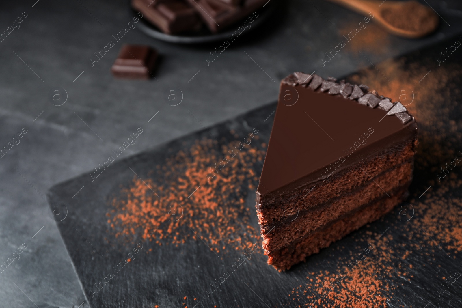 Photo of Delicious chocolate cake on grey table, space for text