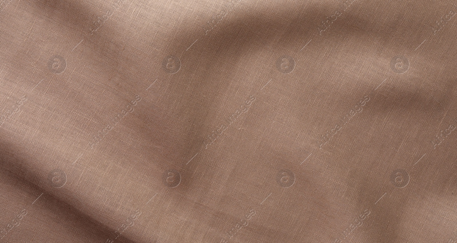 Photo of Texture of brown crumpled fabric as background, top view