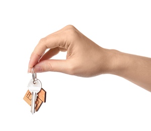 Photo of Woman holding house key with trinket on white background, closeup