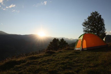 Photo of Color camping tent on hill in mountains