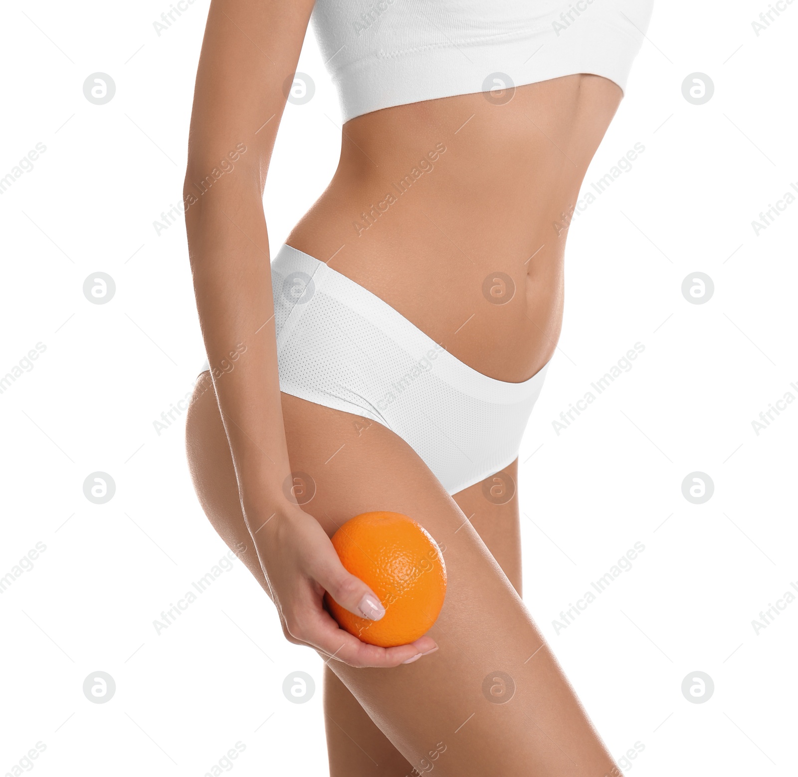 Photo of Closeup view of slim woman in underwear with orange on white background. Cellulite problem concept