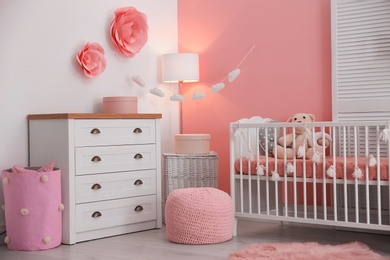 Baby room interior with decorations and comfortable crib