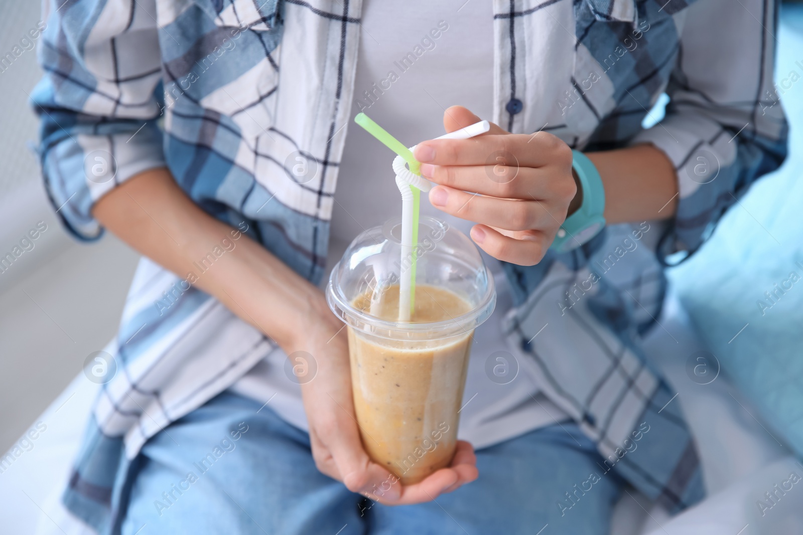 Photo of Young woman with plastic cup of healthy smoothie, closeup