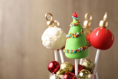Delicious Christmas themed cake pops on blurred background. Space for text