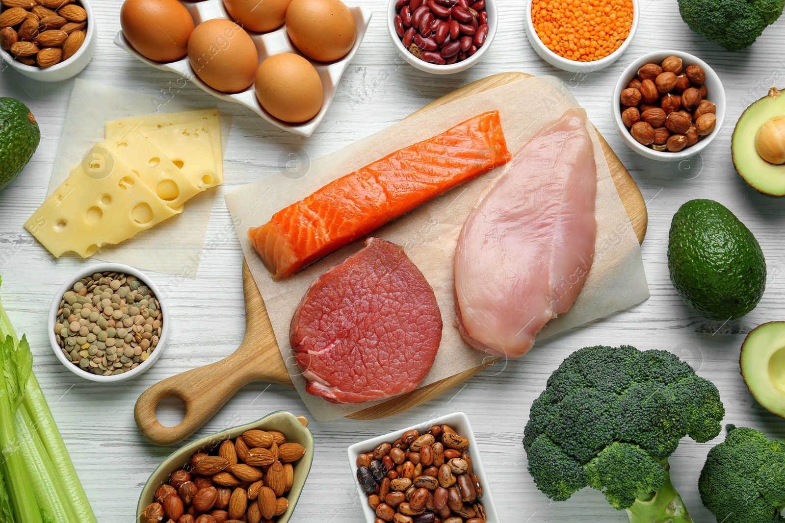 Photo of Different fresh products on white wooden table, flat lay. Sources of essential amino acids