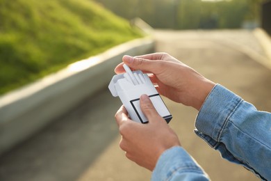 Woman taking cigarette out of pack outdoors, closeup. Space for text