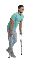 Full length portrait of man with crutches on white background