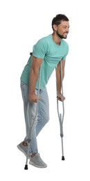 Photo of Full length portrait of man with crutches on white background