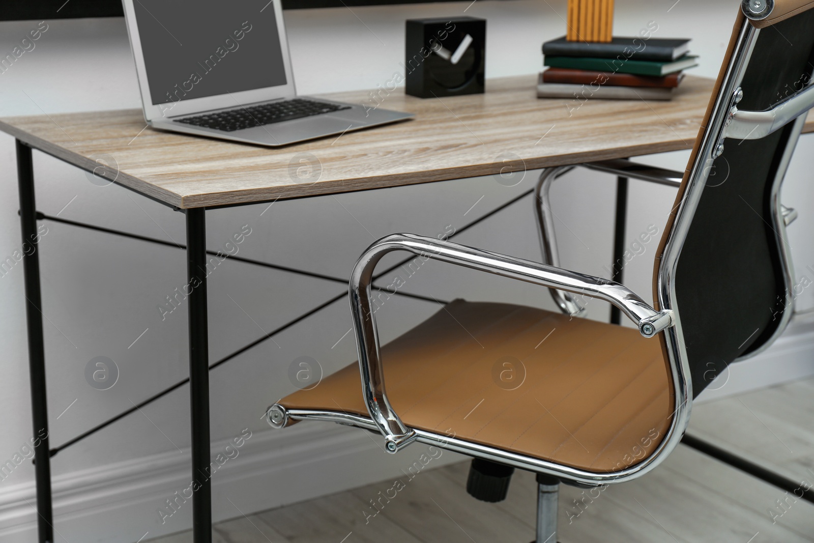 Photo of Stylish workplace interior with modern office chair