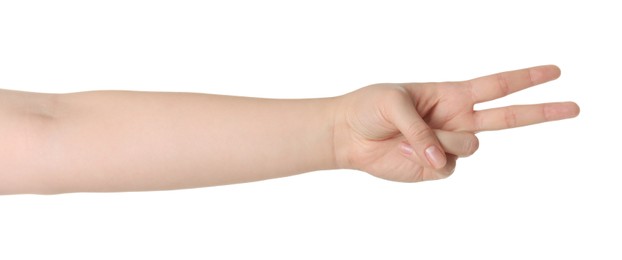 Photo of Playing rock, paper and scissors. Woman making scissors with her fingers on white background, closeup