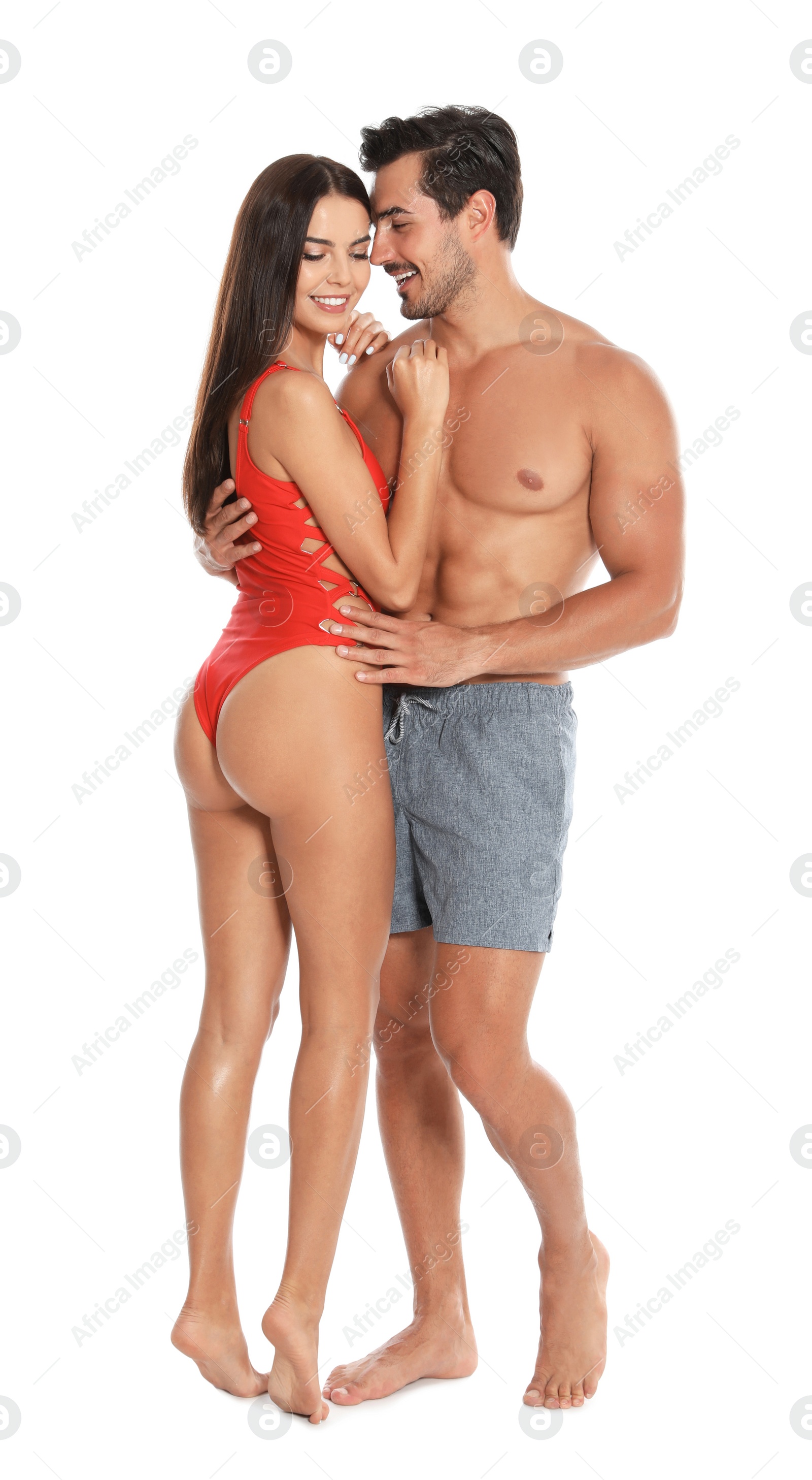 Photo of Young attractive couple in beachwear on white background