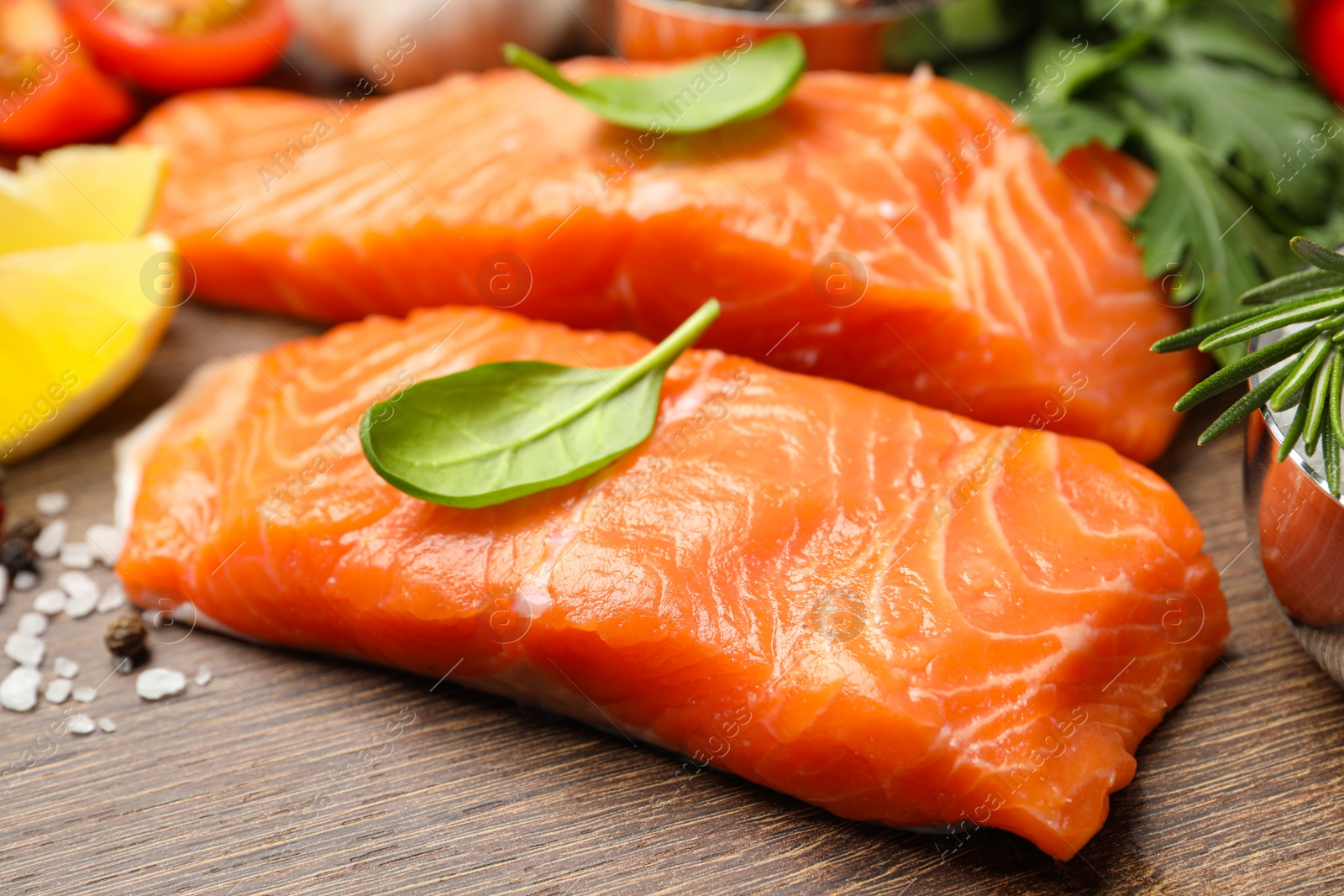 Photo of Fresh salmon and ingredients for marinade on wooden table, closeup