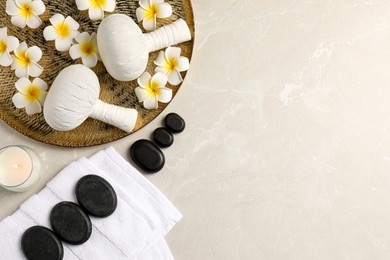 Spa bags, stones and orchid flowers on beige marble table, flat lay. Space for text