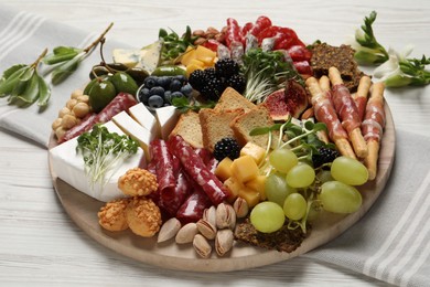 Photo of Different tasty appetizers on white wooden table
