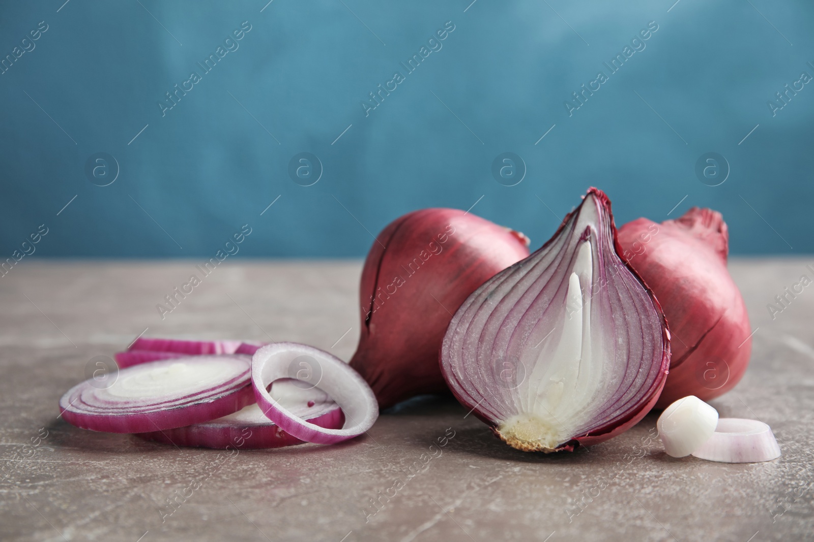 Photo of Ripe red onions on table