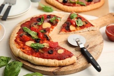 Delicious homemade pita pizza on white wooden table