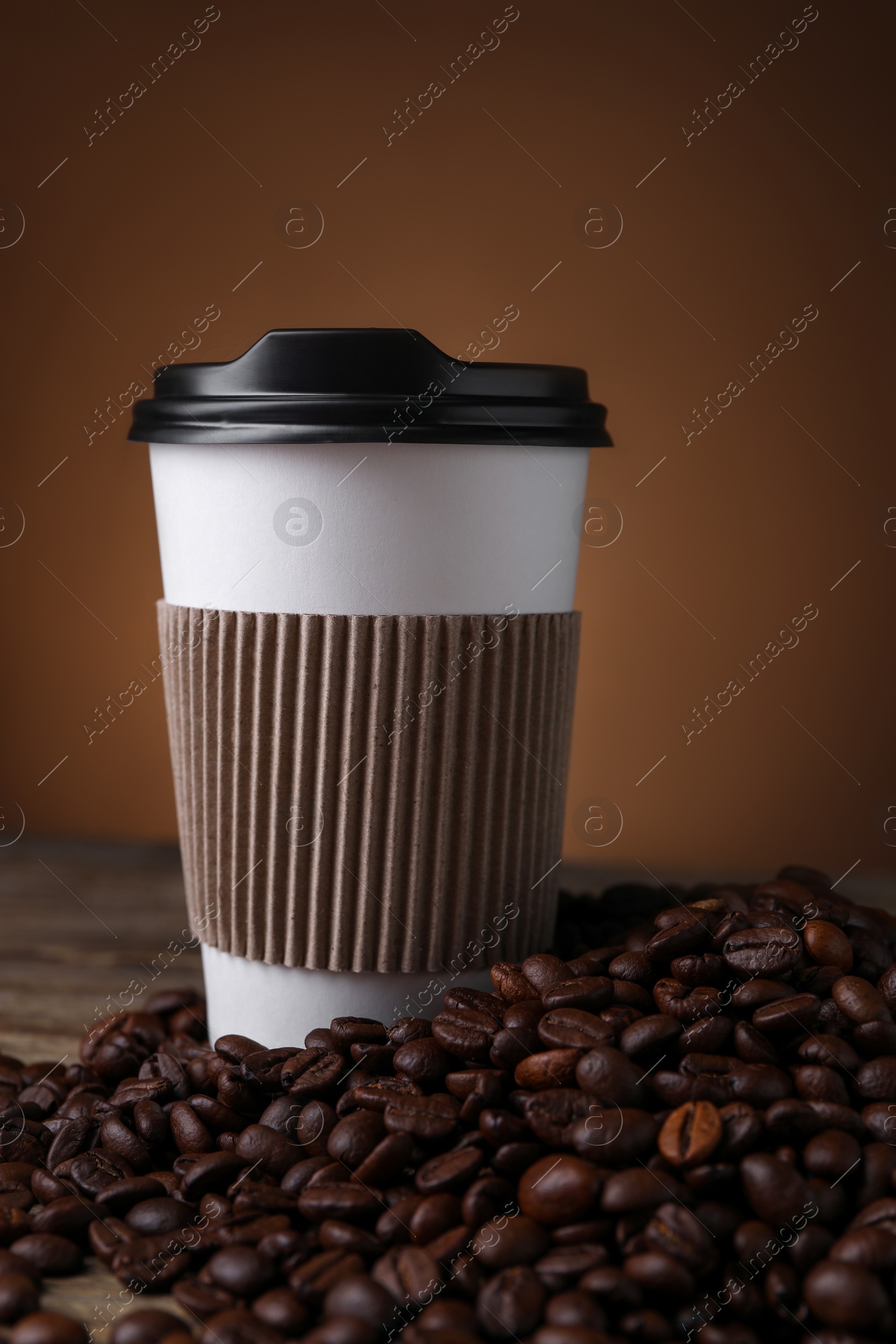 Photo of Coffee to go. Paper cup and roasted beans on table, closeup