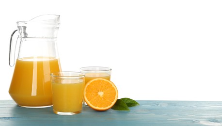 Photo of Delicious orange juice and fresh fruit on light blue wooden table against white background. Space for text