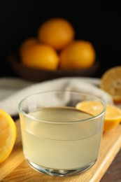 Photo of Freshly squeezed lemon juice in glass bowl on table