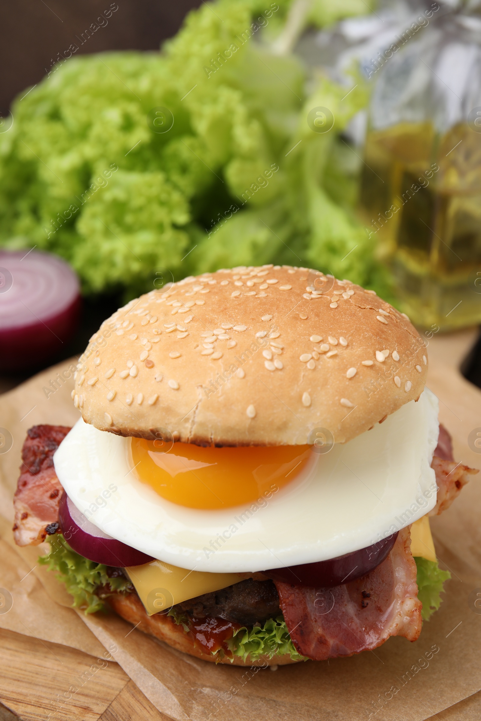 Photo of Delicious burger with fried egg on table, closeup. Space for text