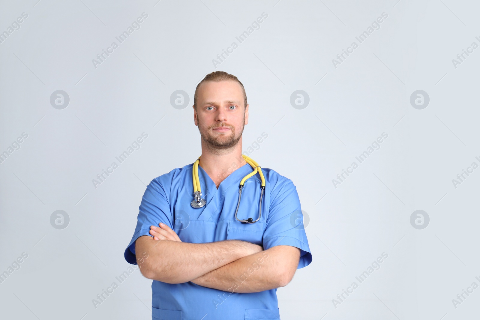 Photo of Portrait of medical assistant with stethoscope on color background