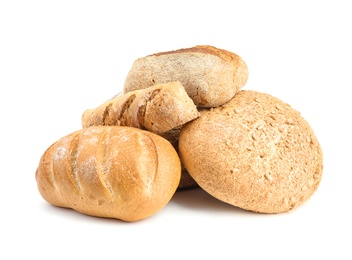 Loaves of different breads on white background