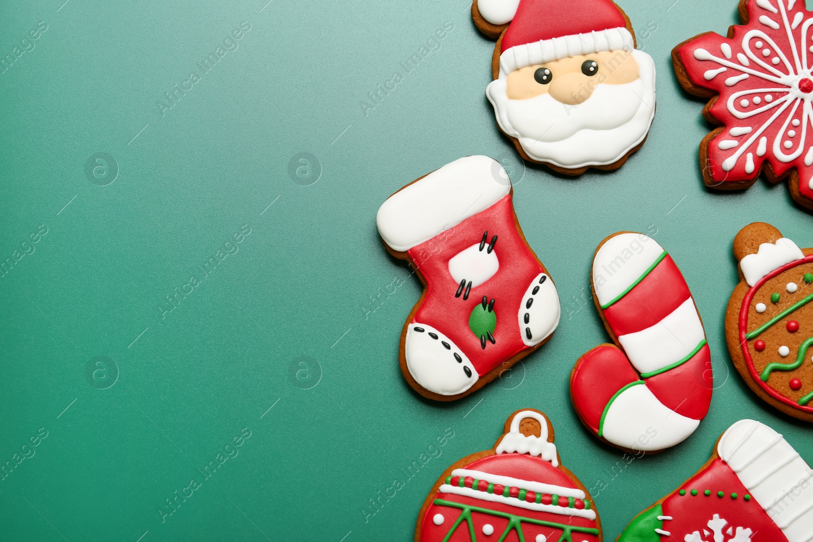 Photo of Different tasty Christmas cookies on green background, flat lay. Space for text