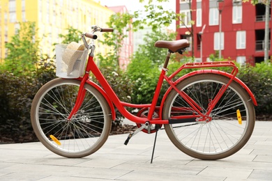 Modern color bicycle with basket in park