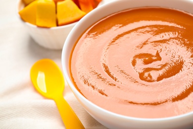 Photo of Healthy baby food in bowl, closeup view