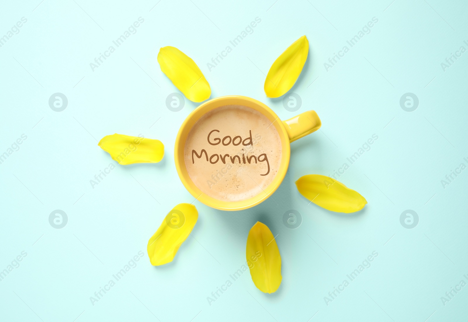 Image of Cup of aromatic coffee and flower petals on light blue background, flat lay. Good morning