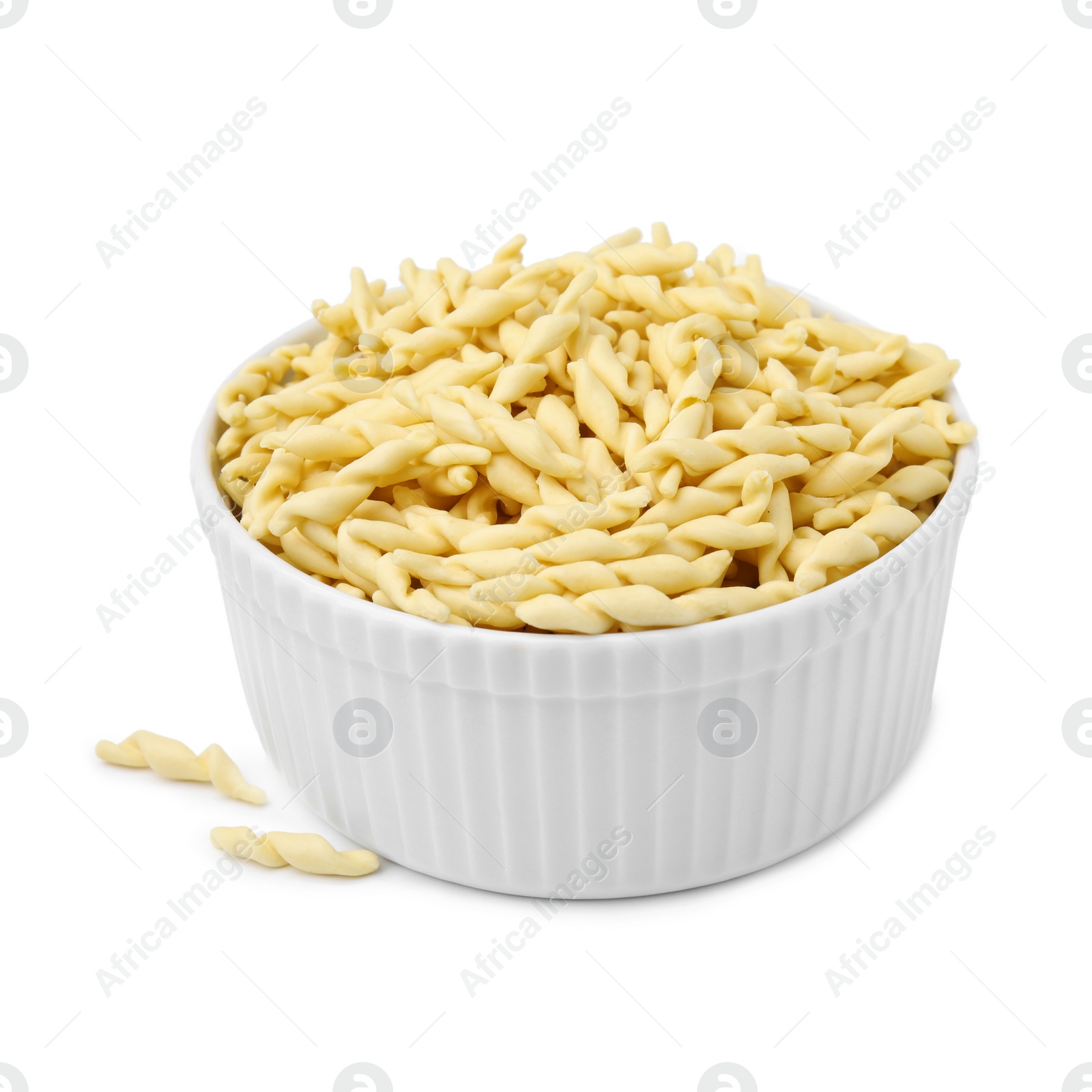 Photo of Bowl with uncooked trofie pasta isolated on white