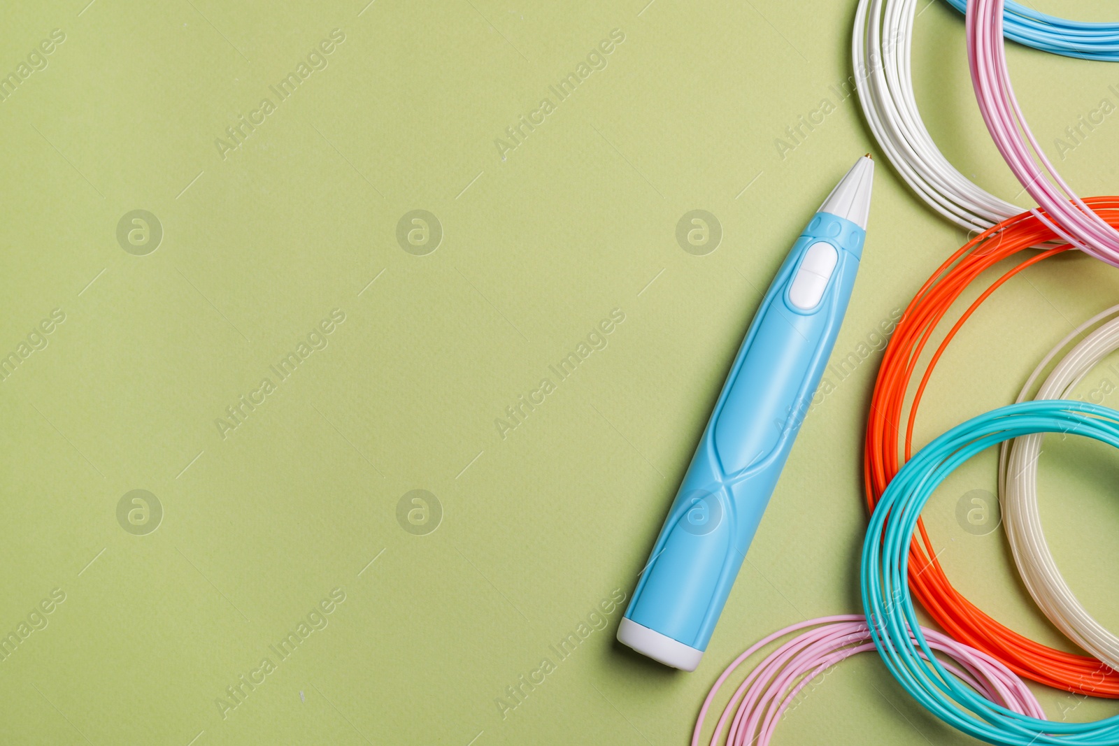 Photo of Stylish 3D pen and colorful plastic filaments on olive background, flat lay. Space for text