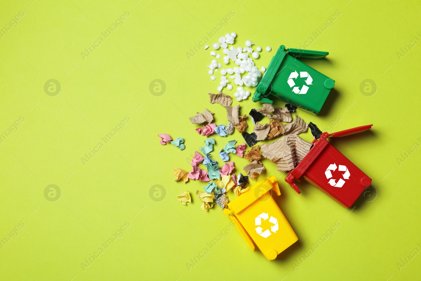 Photo of Trash bins and different garbage on color background, top view with space for text. Waste recycling concept