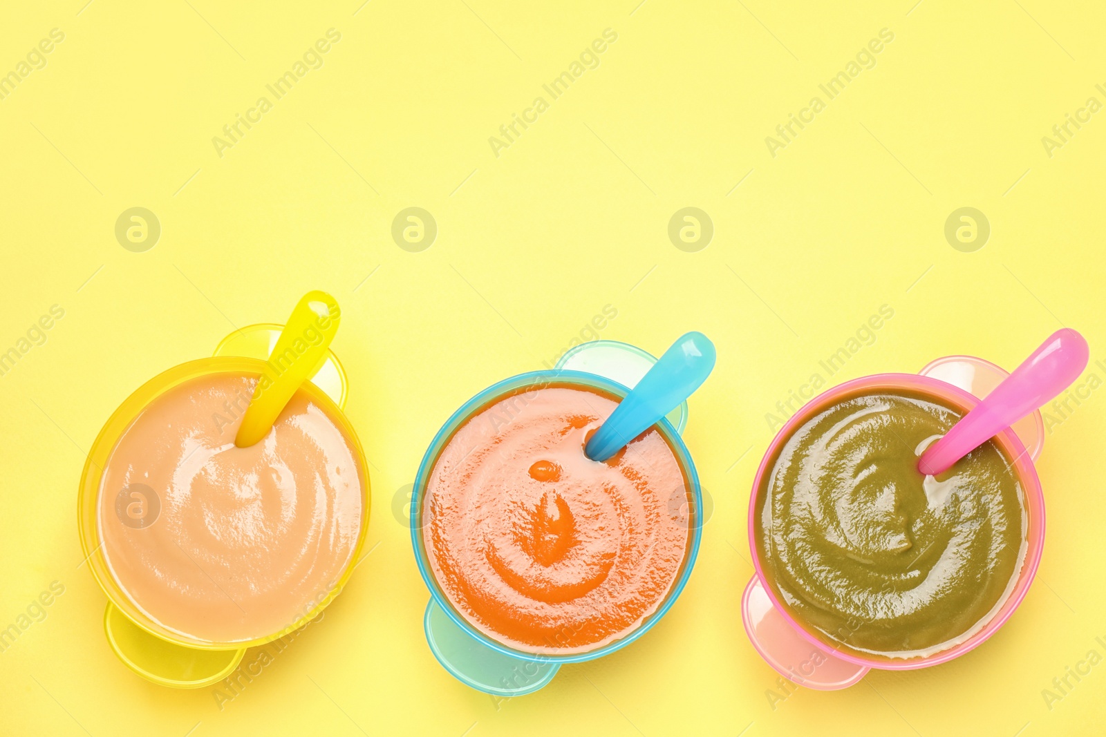 Photo of Healthy baby food on yellow background, flat lay. Space for text