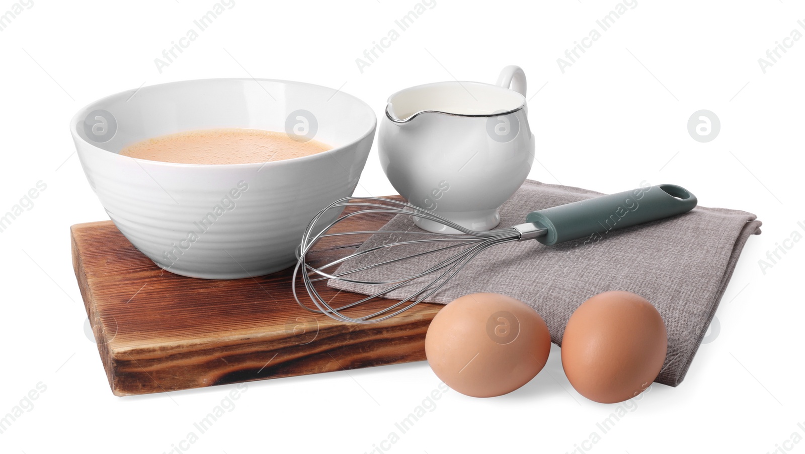 Photo of Metal whisk, beaten eggs and milk isolated on white