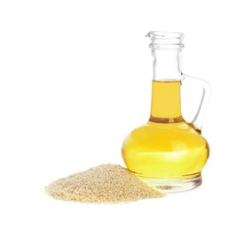 Photo of Glass jug of fresh sesame oil and seeds isolated on white