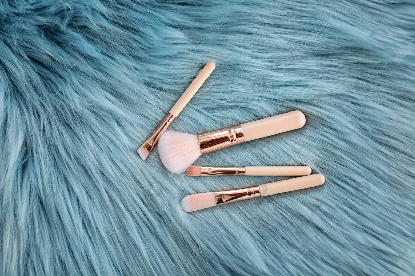 Photo of Flat lay composition with makeup brushes on faux fur