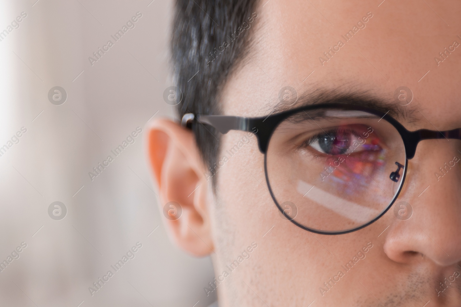 Photo of Man wearing glasses on blurred background, closeup